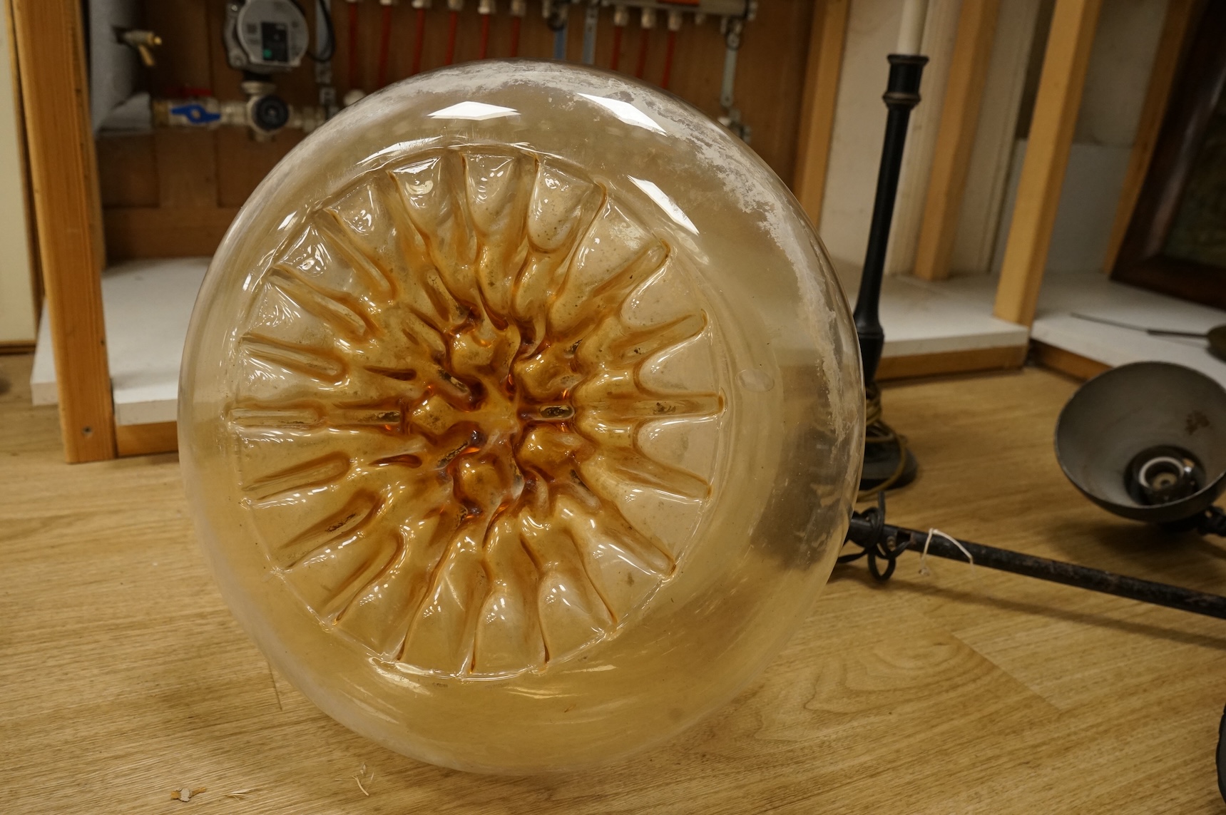 A large 1970's amber and opaque glass ceiling shade, 32cm high, Kandem model 802 adjustable lamp with clamp, 94cm high (fully extended) and a table lamp with toleware shade